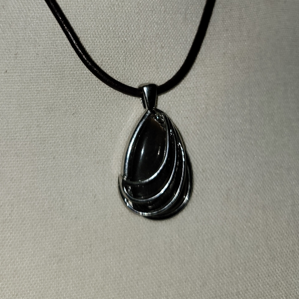 Silver and black pendant with leather cord